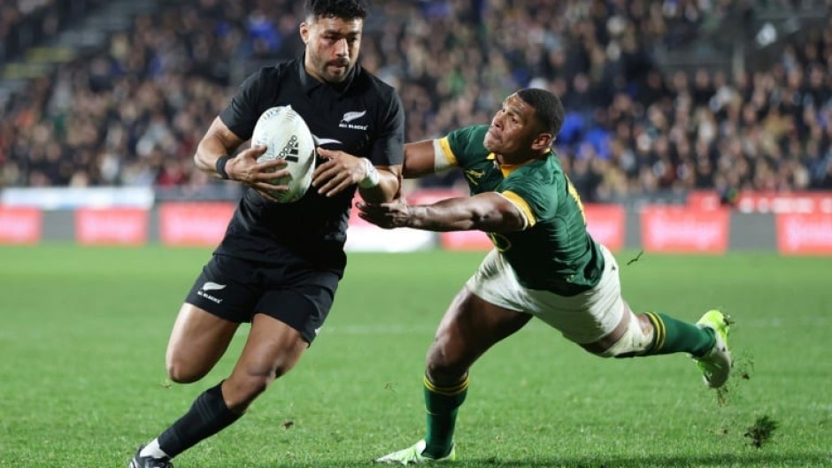 Richie Mo'unga (L) scores the last of four New Zealand tries in a Rugby Championship triumph over South Africa in Auckland on July 15, 2023.
