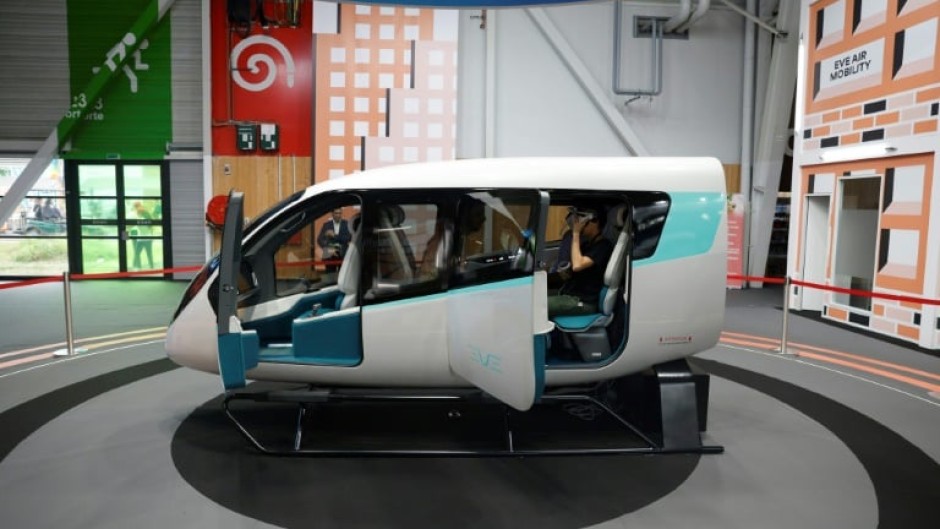Brazil's Embraer and its subsidiary Eve Air Mobility say they will begin manufacturing electric flying cars, a model cabin of which is seen here at a Paris air show in June 2023, at a factory near Sao Paulo as early as 2026