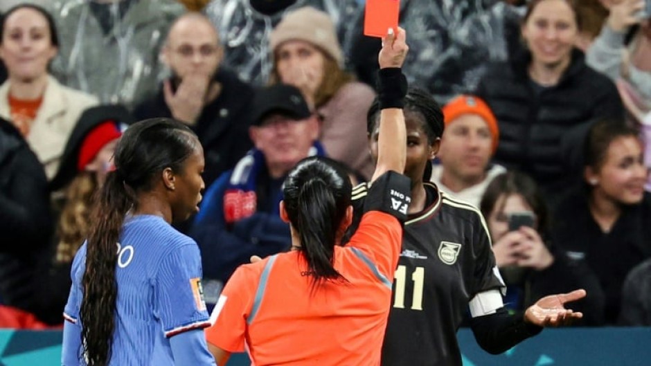 Referee Maria Carvajal shows a red card to Jamaica's forward Khadija Shaw