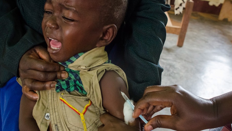 A child reacts as he receives an injection during the nationwide vaccination campaign against measles, rubella and polio.
