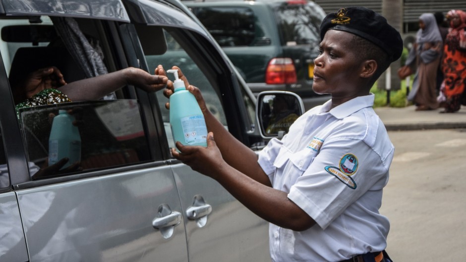 A security officer dispenses hand sanitizer to a passenger at Muhimbili National Hospital in Dar es Salaam, Tanzania.