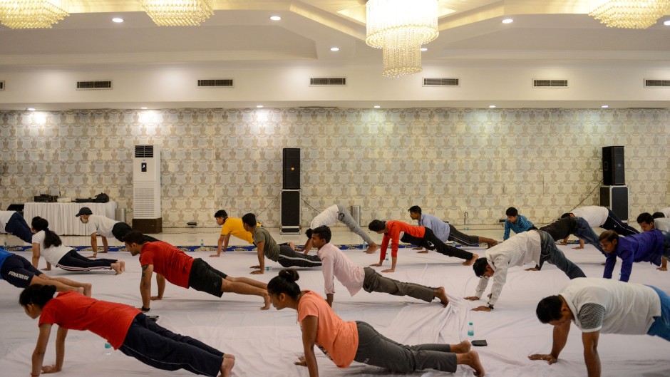 People take part in a yoga session during the International Yoga Day