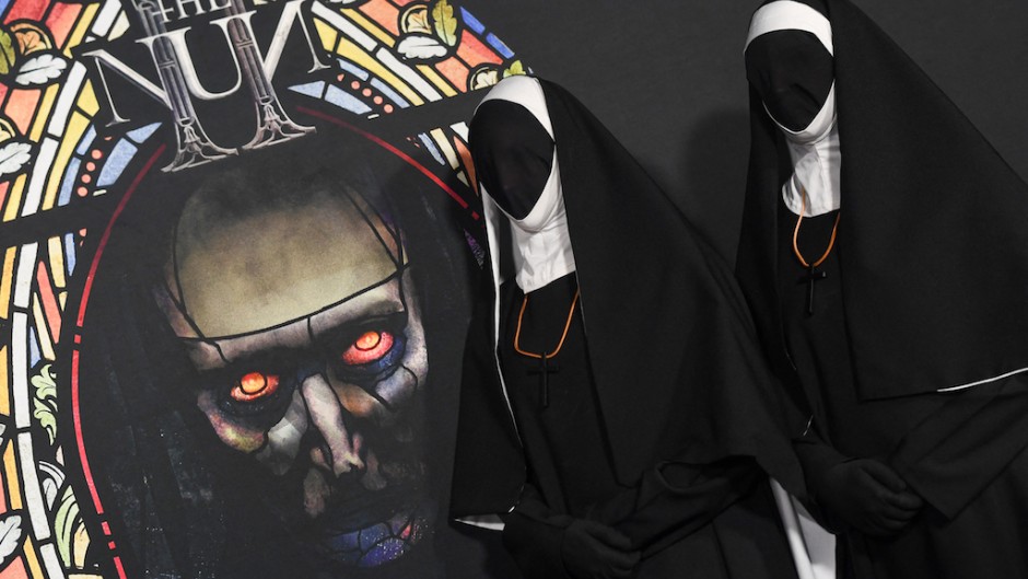 Actors dressed as nuns pose on the red carpet for a special screening of "The Nun II". AFP/Valerie Macon