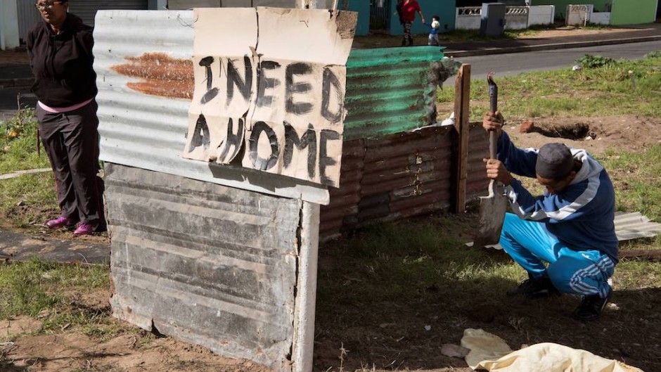 File: A sign on a shack reading "I need a home" in Woodlands, Mitchells Plain. AFP/Rodger Bosch