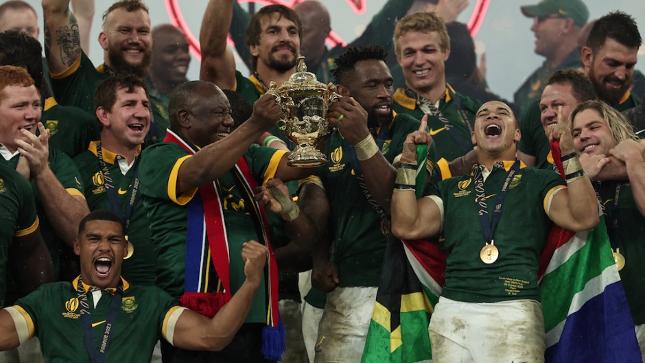 Captain Siya Kolisi and President Cyril Ramaphosa lift the Webb Ellis Cup as South Africa's players celebrate winning the France 2023 Rugby World Cup final match. AFP/Franck Fife