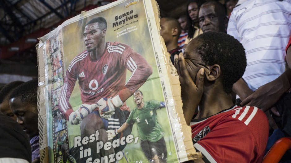 File: A fan cries holding a portrait of the slain Bafana Bafana and Orlando Pirates captain Senzo Meyiwa. AFP/Marco Longari