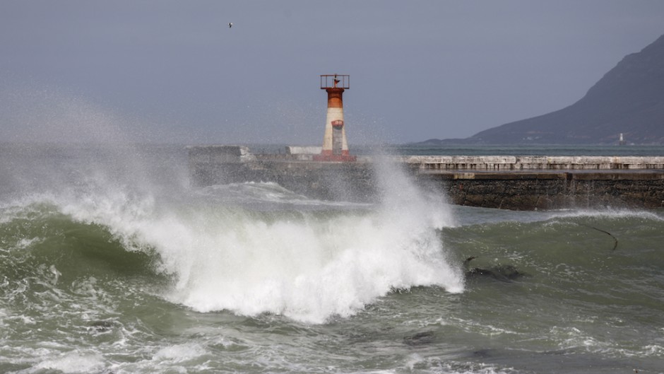 Waves spray water on structures on the seaside of Kalk Bay in Cape Town. AFP/Gianluigi Guercia