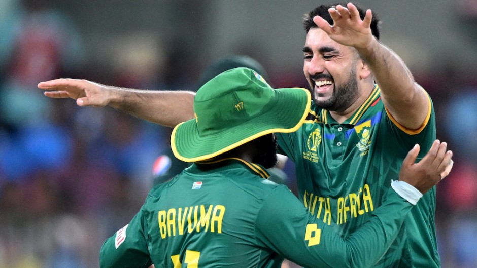 Tabraiz Shamsi celebrates with captain Temba Bavuma after taking a wicket. AFP/Satish Babu
