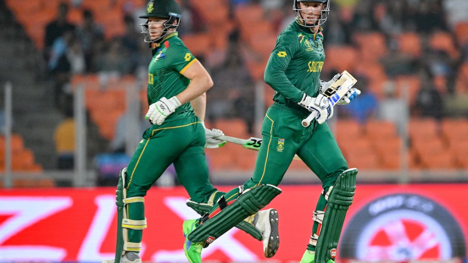 Rassie van der Dussen and David Miller (L) run between the wickets during the 2023 ICC Men's Cricket World Cup ODI match between South Africa and Afghanistan. AFP/Sajjad Hussain