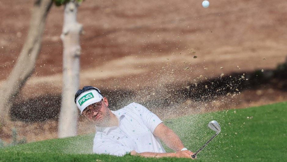 Thriston Lawrence of South Africa plays a shot out of a bunker. AFP/Giuseppe Cacace