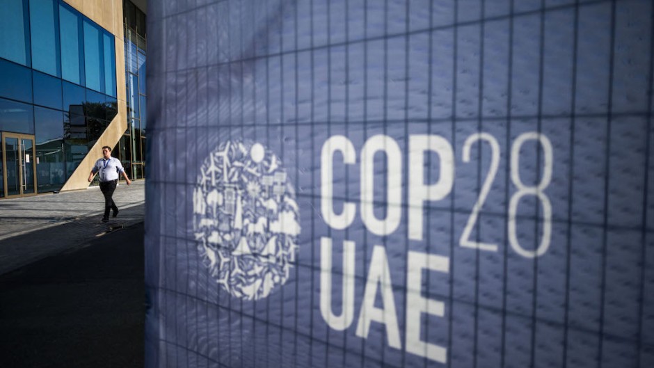 A man walks past a COP28 sign at the venue of the United Nations climate summit in Dubai. AFP/Jewel Samad