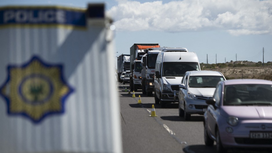 Members of the South African Police Services,the Cape Town Metro Police, and traffic officials, hold a road block on a national highway, checking whether motorists have authorisation to travel, close to Khayelitsha, near Cape Town.