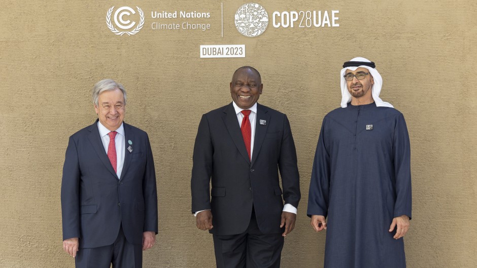 A handout picture provided by the UAE Presidential Court shows shows President of the United Arab Emirates Sheikh Mohamed bin Zayed Al Nahyan (R) and the United Nations Secretary-General Antonio Guterres (L) welcoming South Africa's President Matamela Cyril Ramaphosa prior to the opening ceremony of the COP28 Summit at Dubai's Expo City on December 1, 2023. 