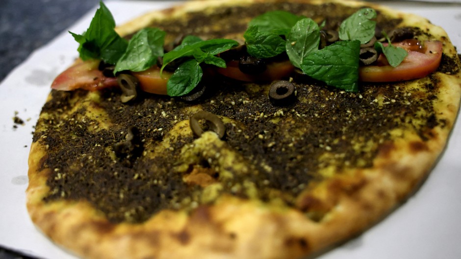 A traditional Lebanese manoushe flatbread topped with mint, tomatoes and olives. AFP/Joseph Eid