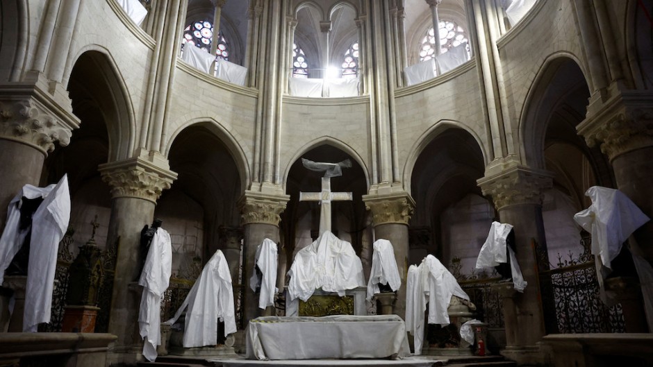 Statues protected by tarpaulins at the Notre-Dame de Paris Cathedral during its reconstruction. AFP/Pool