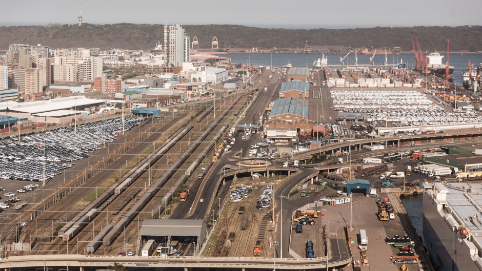 Trucks and cargo vessels are seen at the Port of Durban harbour.