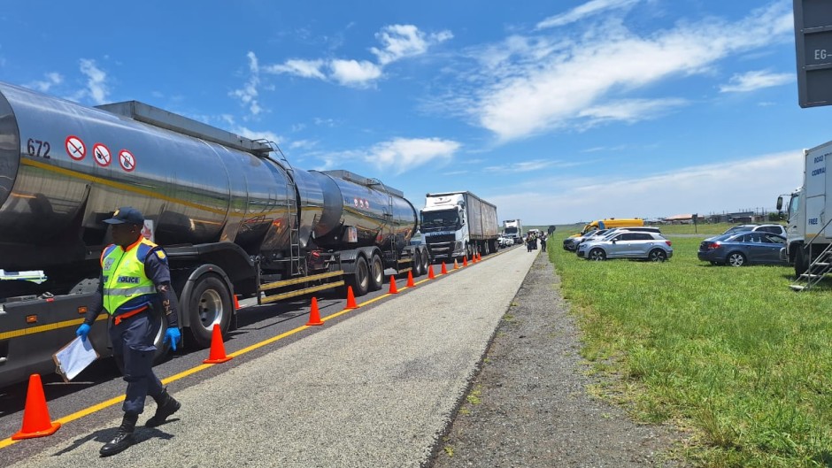 Traffic officers inspecting a vehicle. 