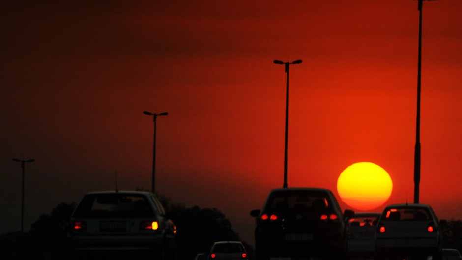 Drivers ride their cars along a highway during sunset in Johannesburg.