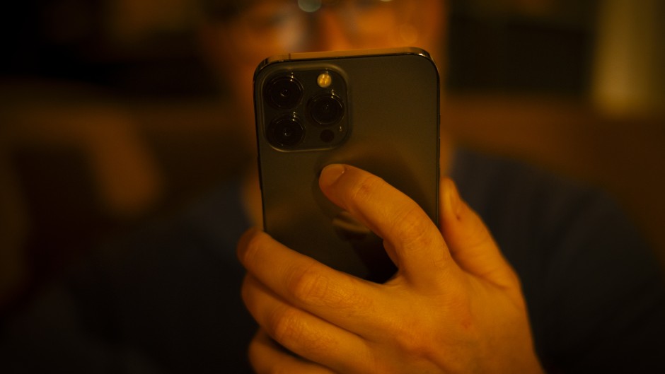 A man is seen using a mobile phone. 