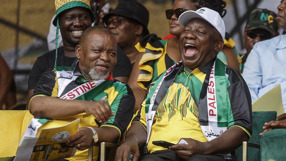 Gwede Mantashe (L), South African Minister of Mineral Resources and Energy and the chairperson of the African National Congress (ANC), South African President and president of the ANC Cyril Ramaphosa (R), react as they attend the 112th ANC Anniversary rally in Mbombela on January 13, 2024.