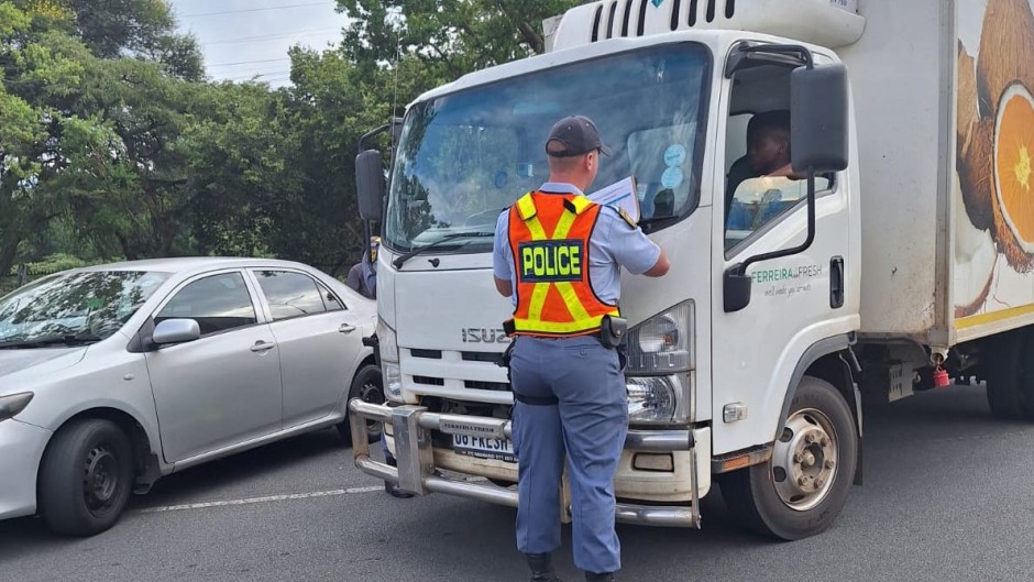 A police officer at a vehicle during Operation Shanela. eNCA/Bafedile Moerane