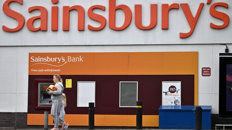 A shopper walks away from a Sainsbury's supermarket store in Tonbridge. AFP/Ben Stansall