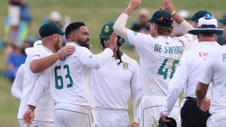 South Africa’s Dane Piedt (L) takes the wicket of New Zealand’s Neil Wagner during day two of the second cricket Test match between New Zealand and South Africa Seddon Park in Hamilton on February 14, 2024.