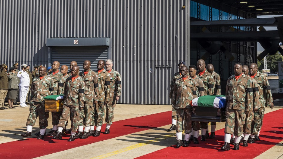 SANDF members carry the flag-draped coffins of Captain Simon Mkhulu Bone and Lance Corporal Irven Thabang Semono during a ceremony at the Waterkloof Air Force Base. AFP/Marco Longari