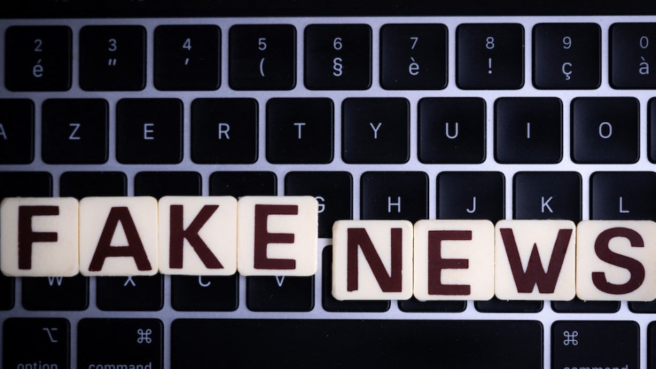 File: This illustration photograph shows letters reading "fake news", against a laptop keyboard. AFP/Sebastien Bozon