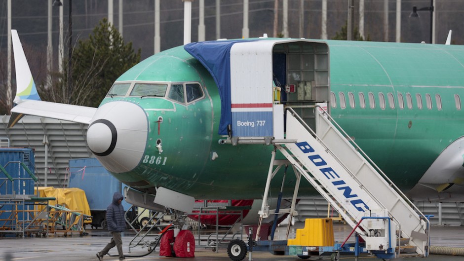 A person walks past a Boeing 737-8 MAX parked in production at Renton Municipal Airport. AFP/Jason Redmond