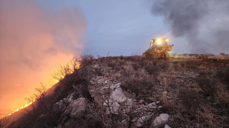 A Texas A&M Forest Service bulldozer building a containment line as it battles the Windy Deuce Fire in Moore County, Texas. AFP