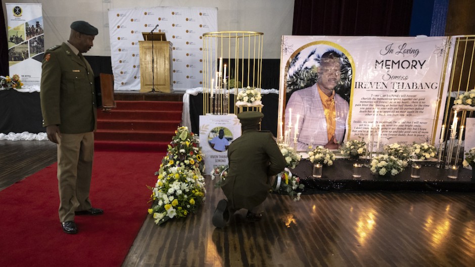 Soldiers lay flowers near a commemorative photograph of SANDF Lance Corporal Thabang Semono. AFP/Olympia De Maismont
