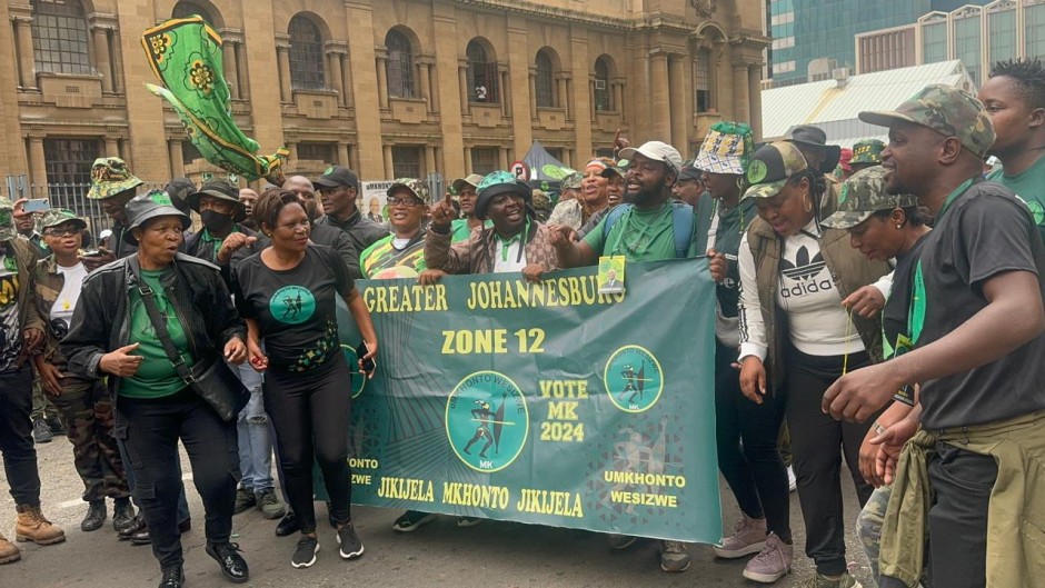 MK Party supporters with their banner outside court