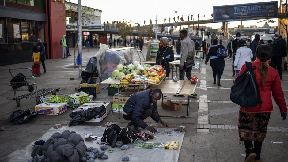File: An informal vendor sets up his stall. AFP/Michele Spatari