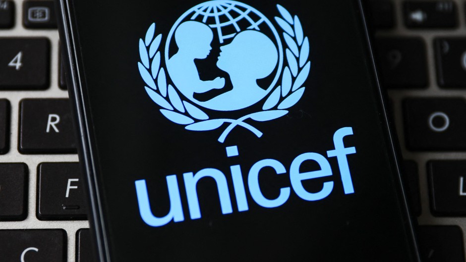 File: UNICEF logo is displayed on a mobile phone screen.