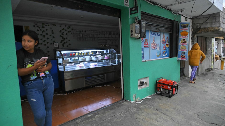 An electricity generator is seen outside a shop during the energy rationing in Quito. AFP/Rodrigo Buendia