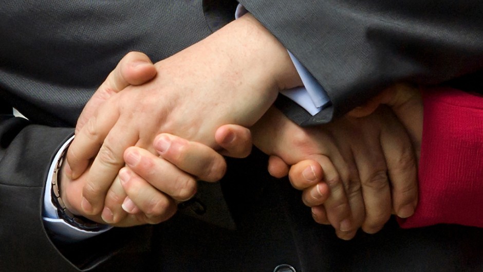File: People shaking hands. AFP/Fabrice Coffrini
