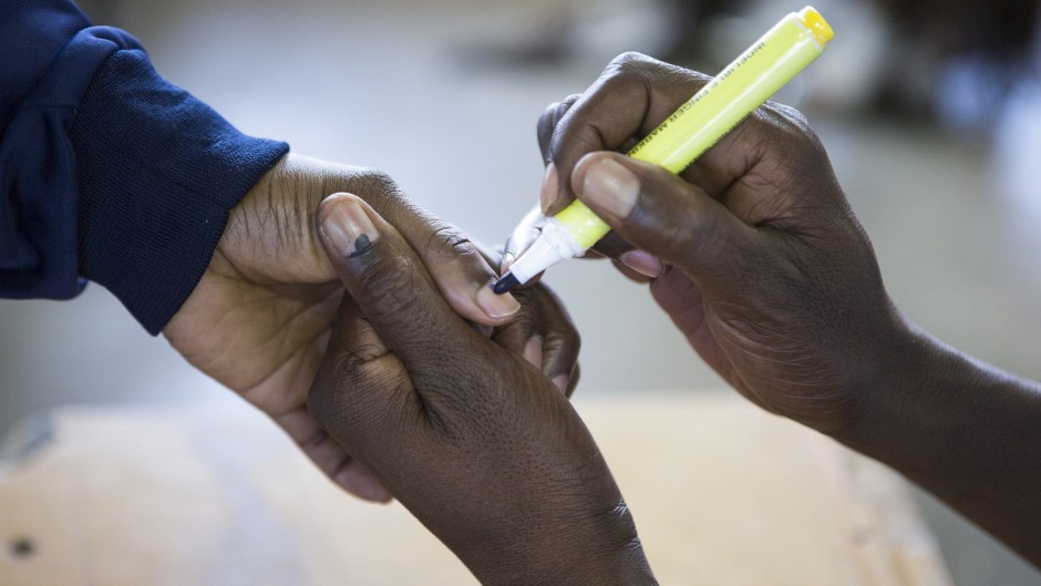 A voter gets a finger inked at a polling station on May 8, 2019 during the legislative and presidential elections in South Africa.