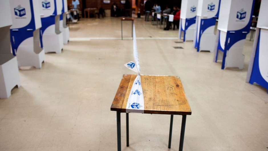 File: Tape of the IEC demarcates a polling station. AFP/Rodger Bosch