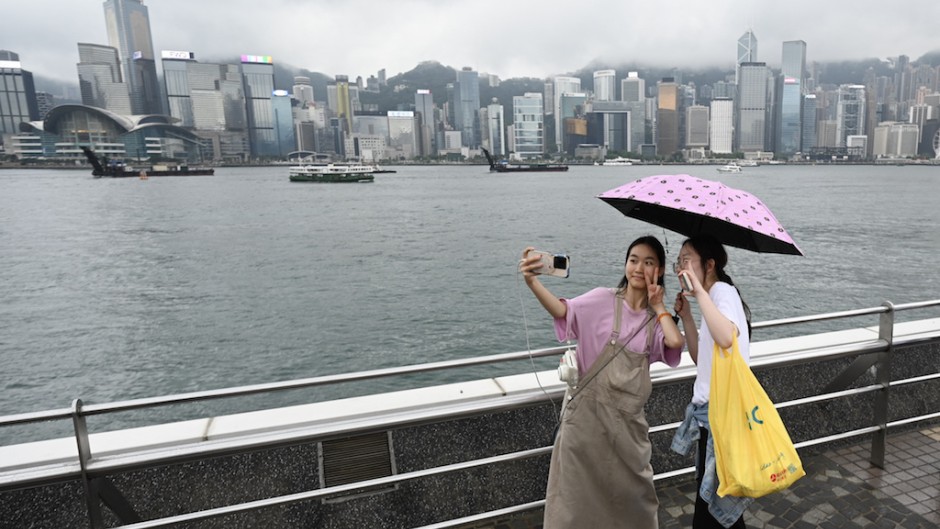 Tourists from mainland China visit the Tsim Sha Tsui waterfront in Hong Kong. AFP/Peter Parks