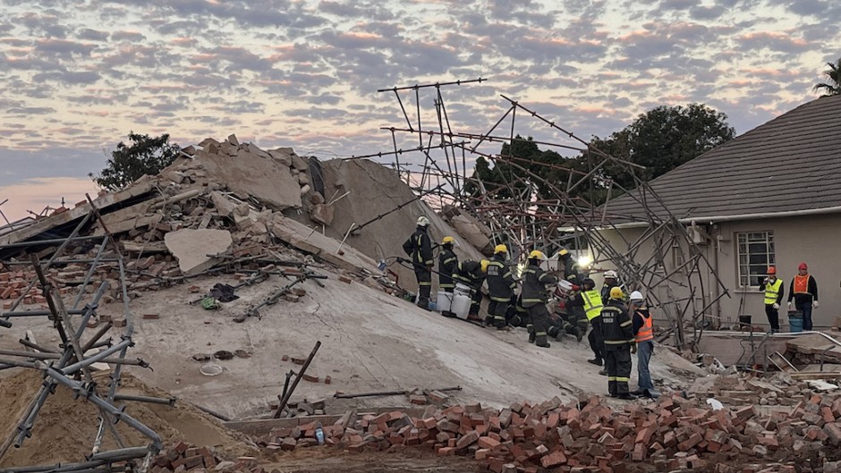 Rescue workers are seen at the scene of a collapsed building in George. AFP/Willie van Tonder