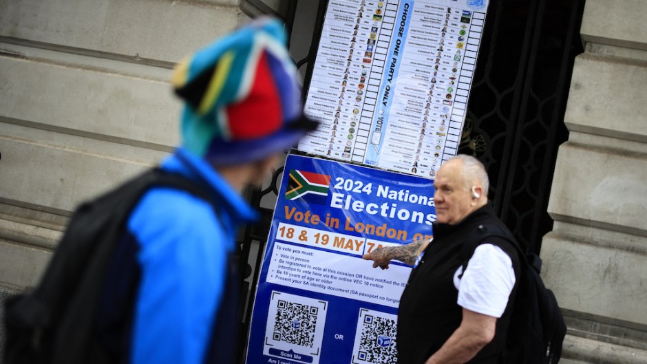 A person points at a poster outside the South African High Commission in central London. AFP/Benjamin Cremel
