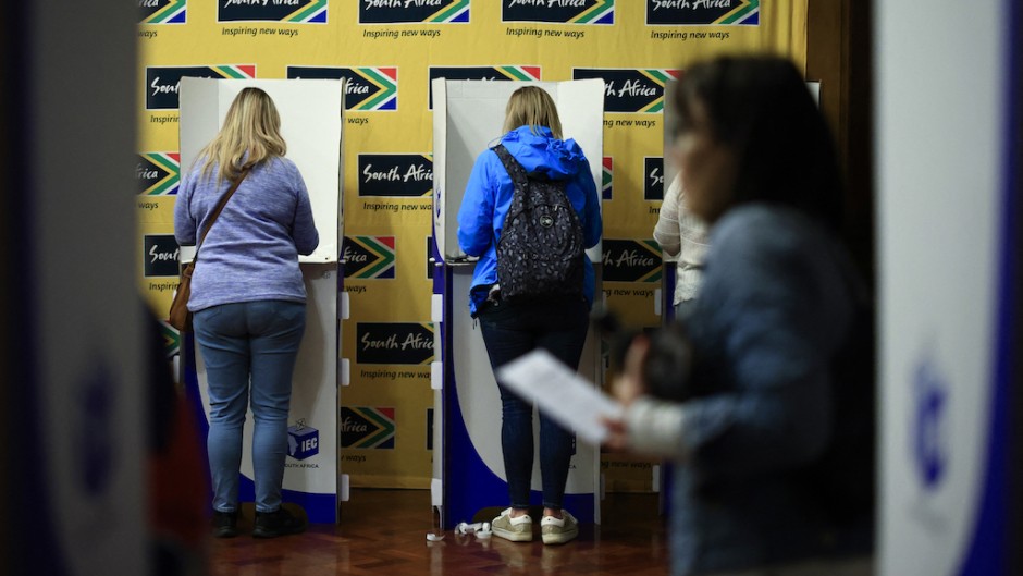 People mark their ballot papers as they vote in the South African general election, at the South African High Commission in central London. AFP/Benjamin Cremel