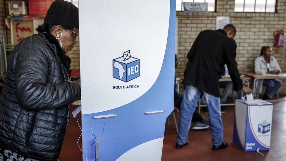 A voter marks her ballot papers in a voting booth. AFP/Phill Magakoe