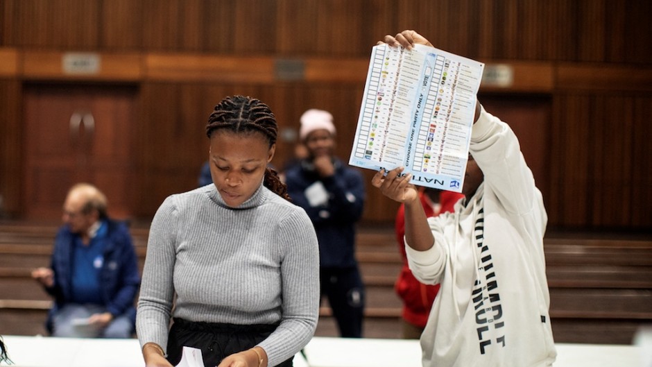 An IEC official holds up a marked ballot during the vote counting process. AFP/Gianluigi Guercia