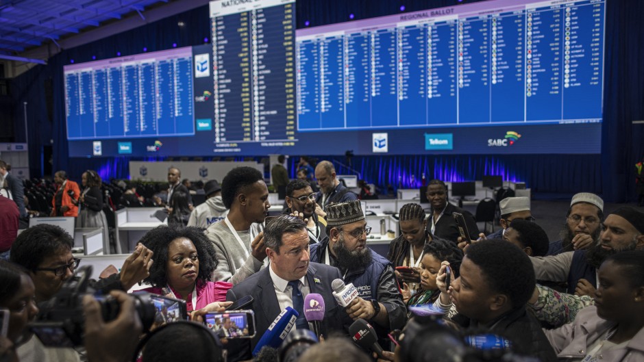 Leader of the Democratic Alliance (DA), South African main opposition party, John Steenhuisen (C) speaks with the media at the Independent Electoral Commission (IEC) National Results Center in Midrand on May 31, 2024. 