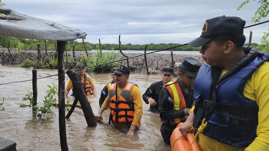 firefighters carrying out rescue work in a flooded area in Nacaome, Valle department, Honduras. AFP/Honduran Firefighters