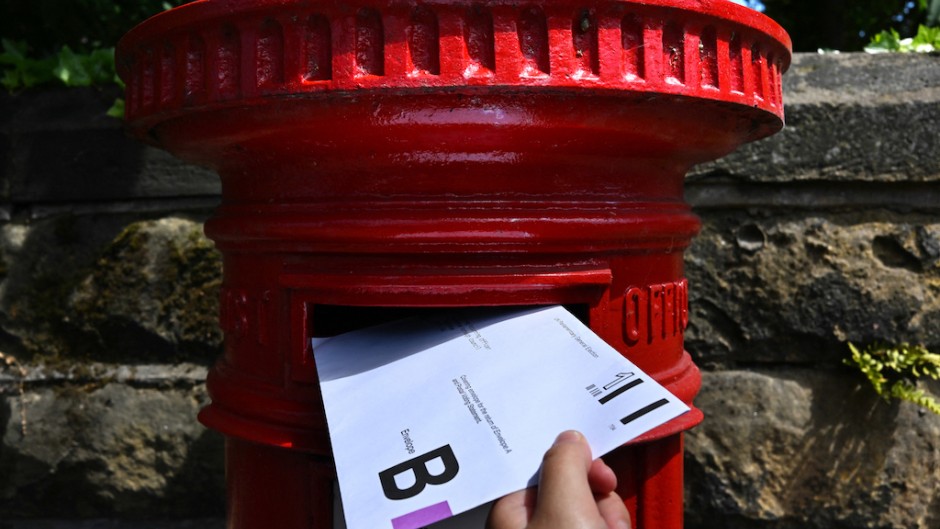 An envelope containing a Postal Vote for the upcoming UK General Election is posted in Birkenhead. AFP/Paul Ellis