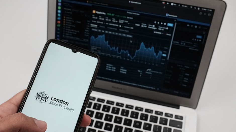 File: A LSE (London Stock Exchange) logo seen on a smartphone and an Exchange graph. AFP/Nikolas Kokovlis / NurPhoto