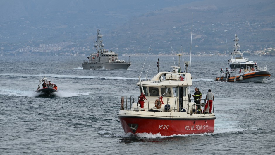 Rescue boats return to Porticello harbor near Palermo, after they found two bodies, on August 21, 2024 two days after the British-flagged luxury yacht Bayesian sank. 